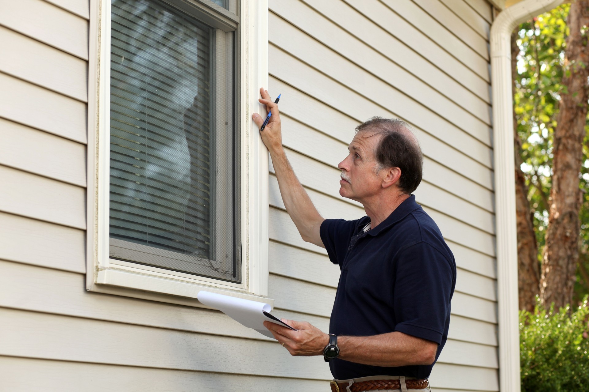 Home inspector checking window frame structure